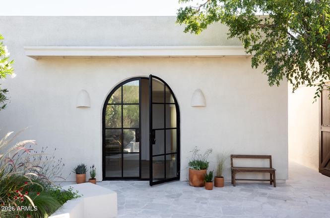 Exterior street view of 1920s Spanish Revival home with terracotta tile roof — Arizona